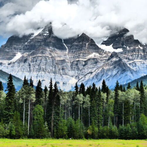 Photos of Canada, a mountain shrouded in cloud with trees at the foot