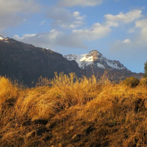 Photos of Peru, sunset over the snow capped mountains.
