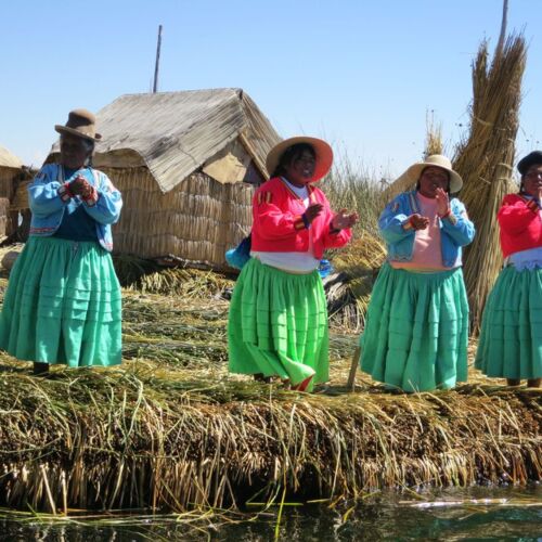 Photos of Peru, Uris women singing on the reed island with colourful traditional dress.