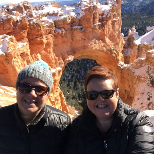 Natural Bridge, Bryce NP Kerry and Claire at a viewpoint with a sandstone bridge behind.