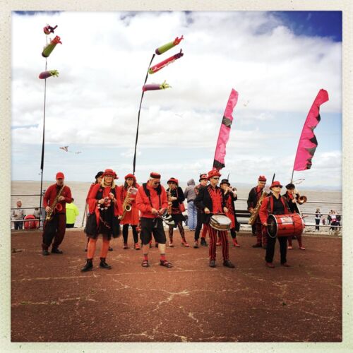 Catch the wind kite festival People playing in a band on the beach.