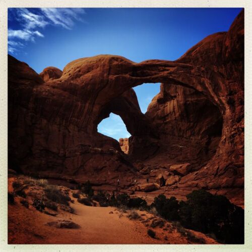 Double Arch, Arches NP An arch with two holes against a sandstone floor