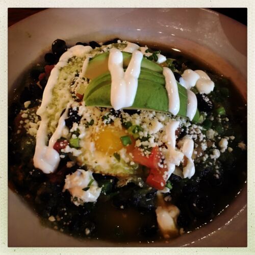 The Mexican breakfast... A plate of mexican black beans, guacamole, peppers and sour cream