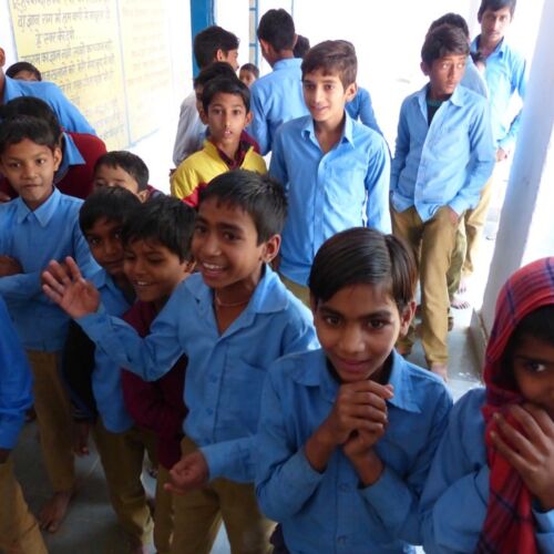 Teaching school children a song in India Indian school children laughing