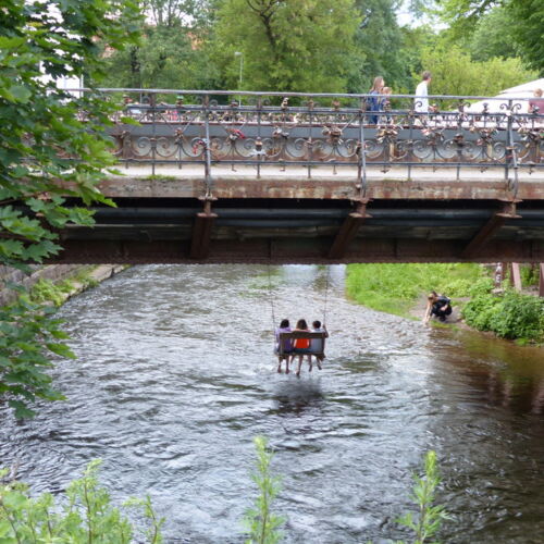 The bridge into Užupis A bridge with children swinging underneath